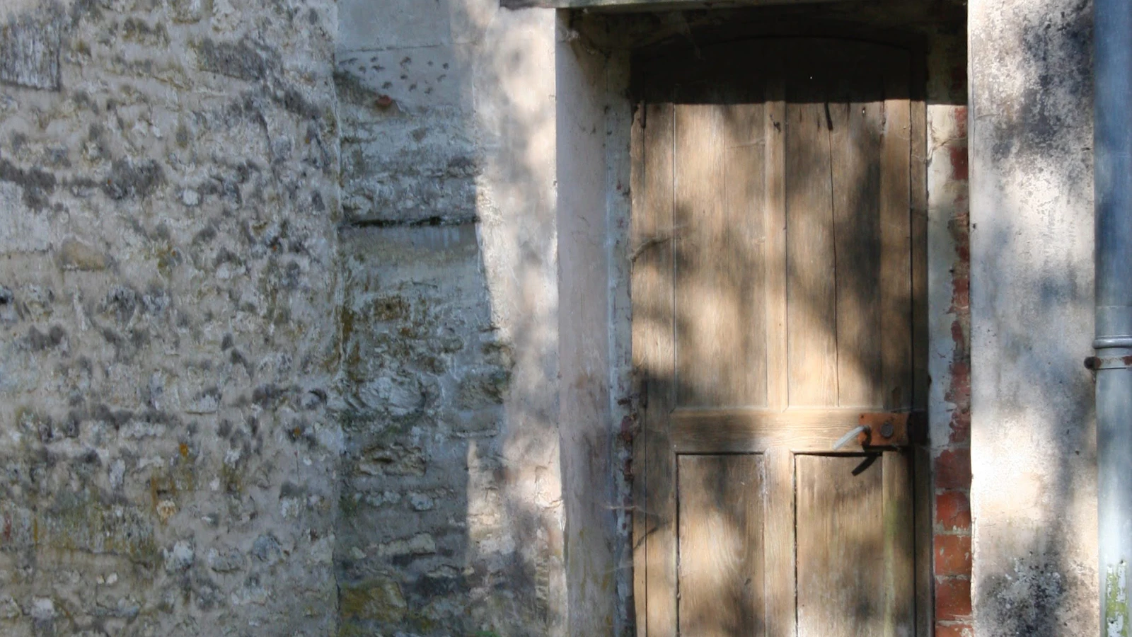 An old wooden door set in a stone building