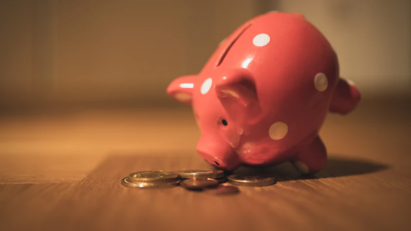 A pink piggy bank on a wooden table