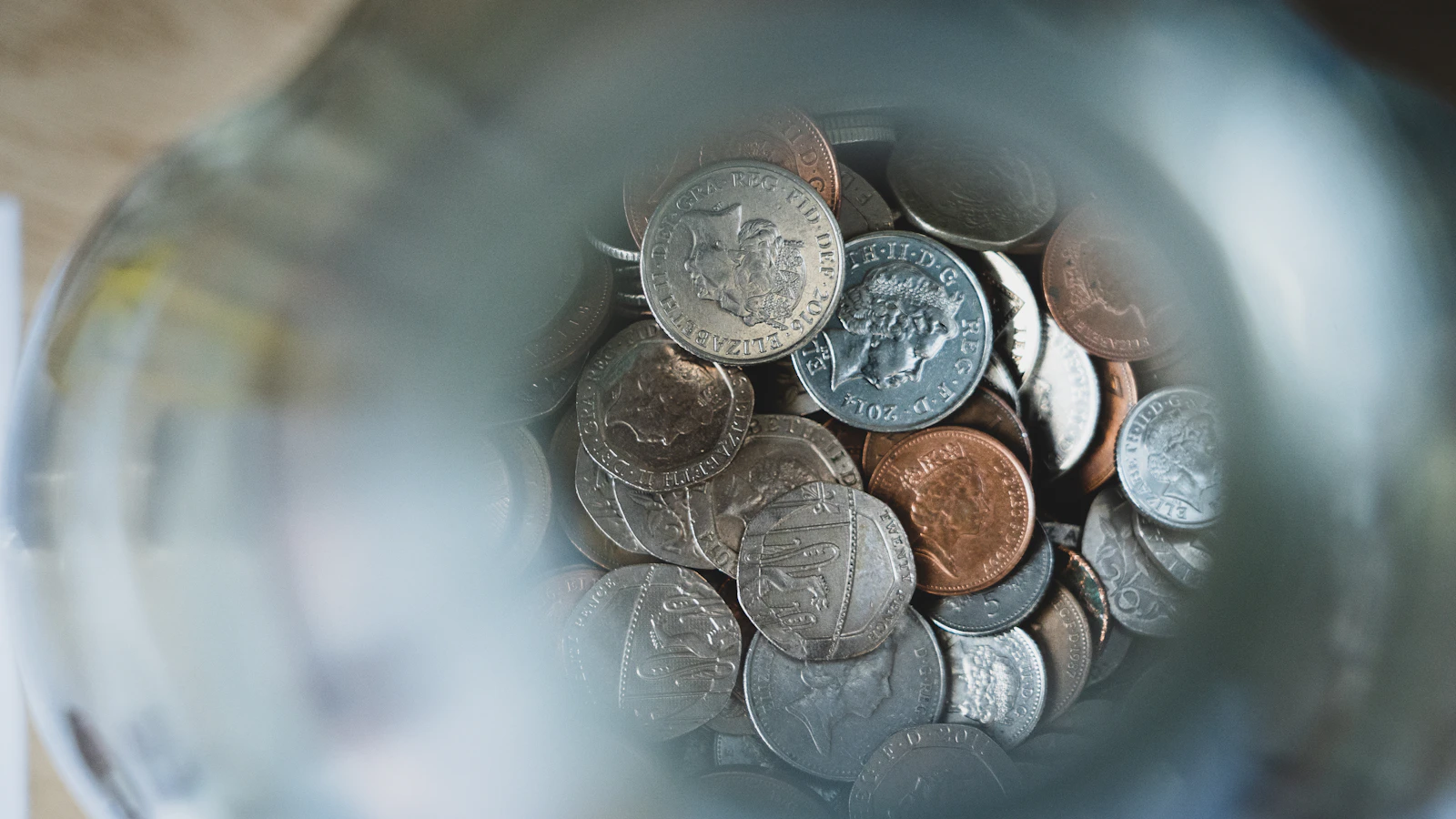 Silver round coins on a blue round container