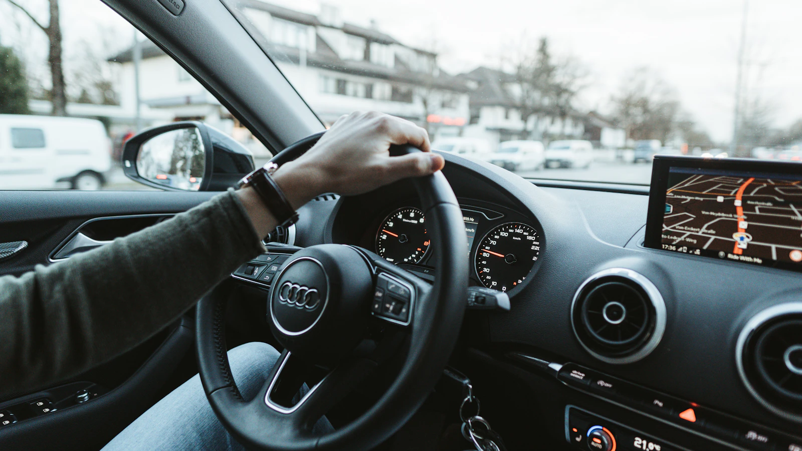 A person driving a car during daytime