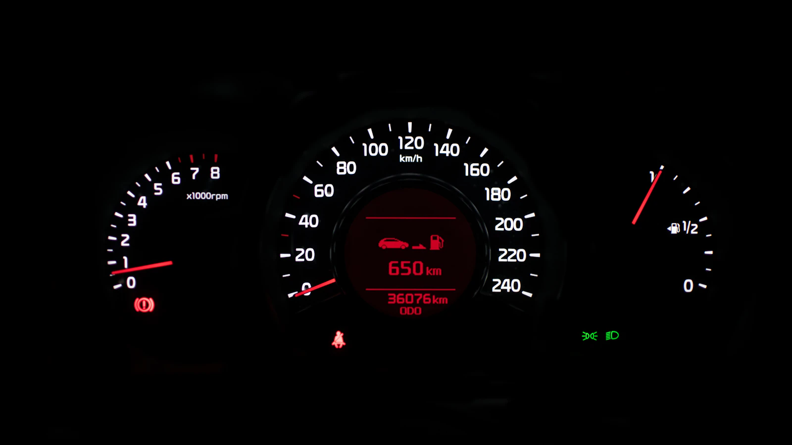 A closeup photo of a black car instrument cluster panel