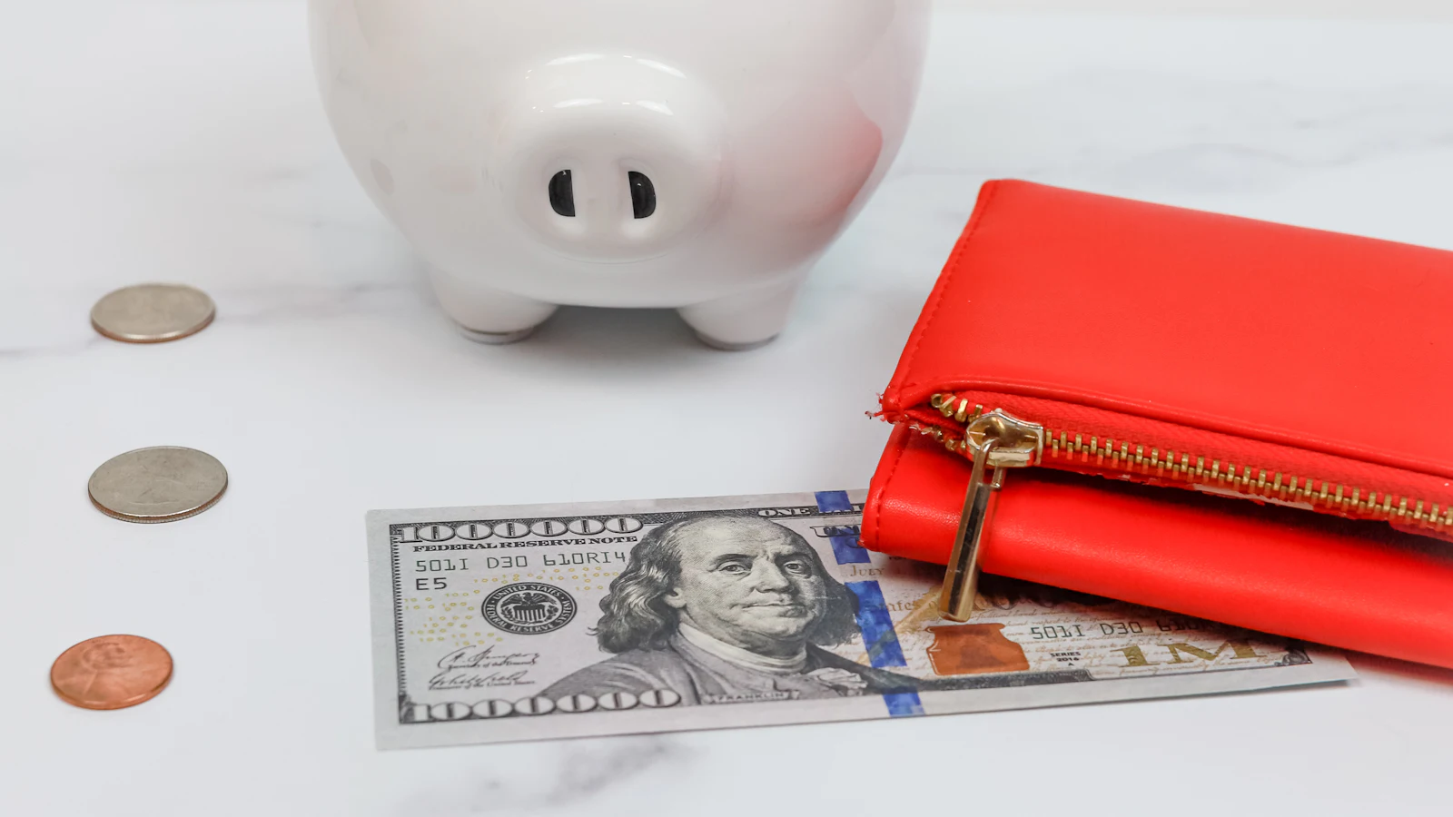 A piggy bank surrounded by a small pile of coins