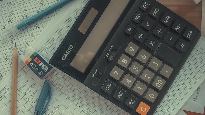 A calculator sitting on top of a pile of tax papers